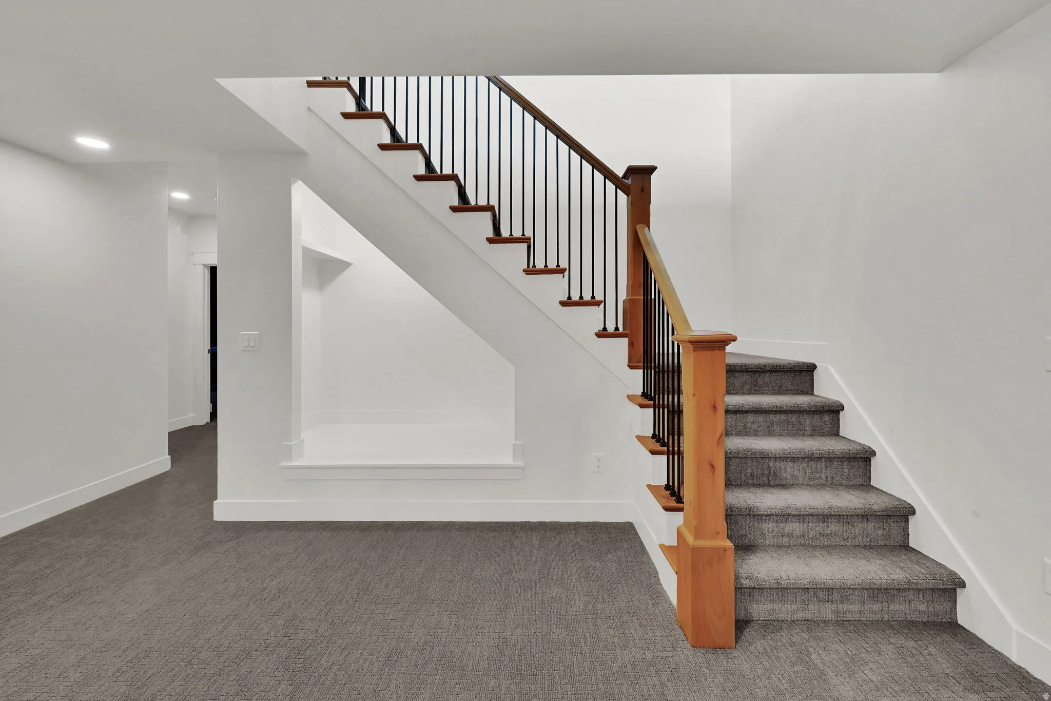 Staircase with carpet floors and baseboards