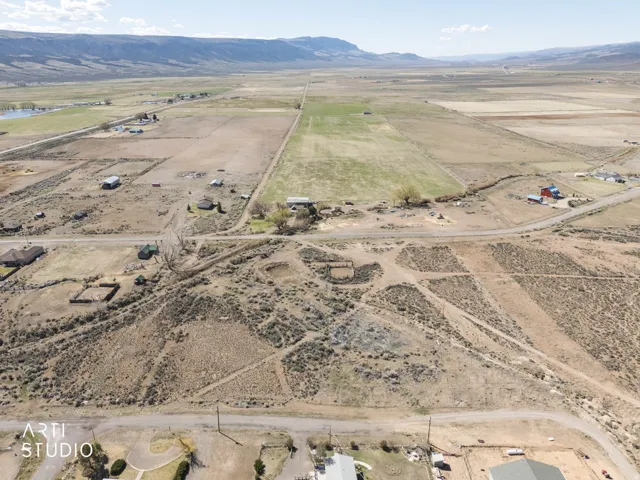 Aerial view of property and surrounding area with rural landscape and a mountain backdrop