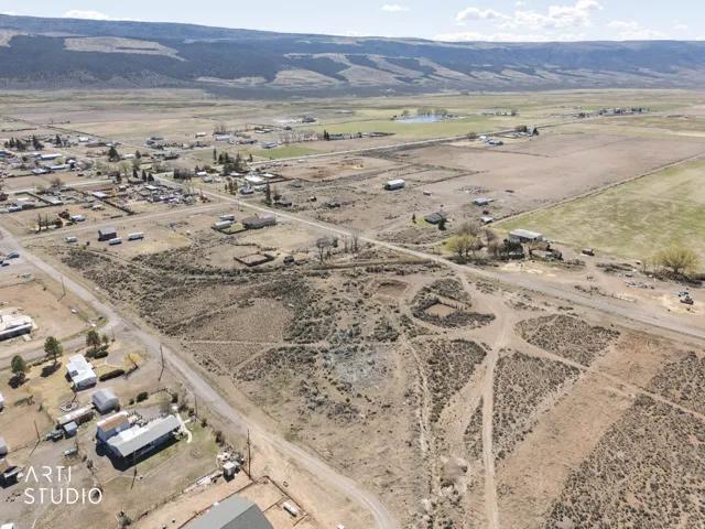 Aerial overview of property's location with rural landscape and a mountain backdrop