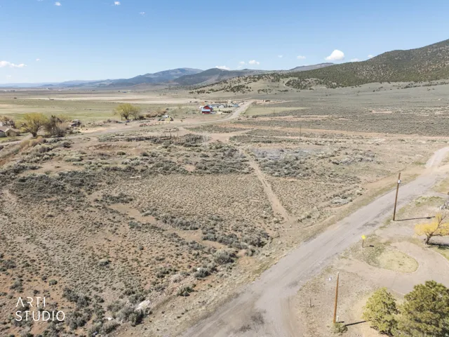 Aerial view of sparsely populated area with a mountainous background and a desert landscape