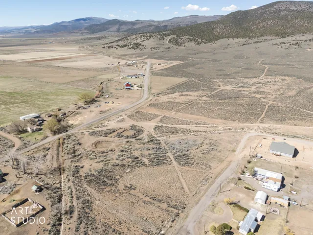 Aerial view of property and surrounding area with rural landscape and a mountain backdrop