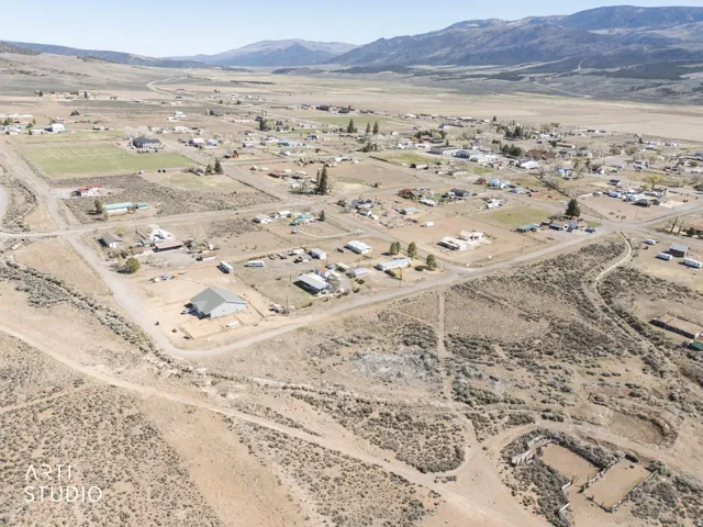 Aerial view of property's location with mountains and rural landscape