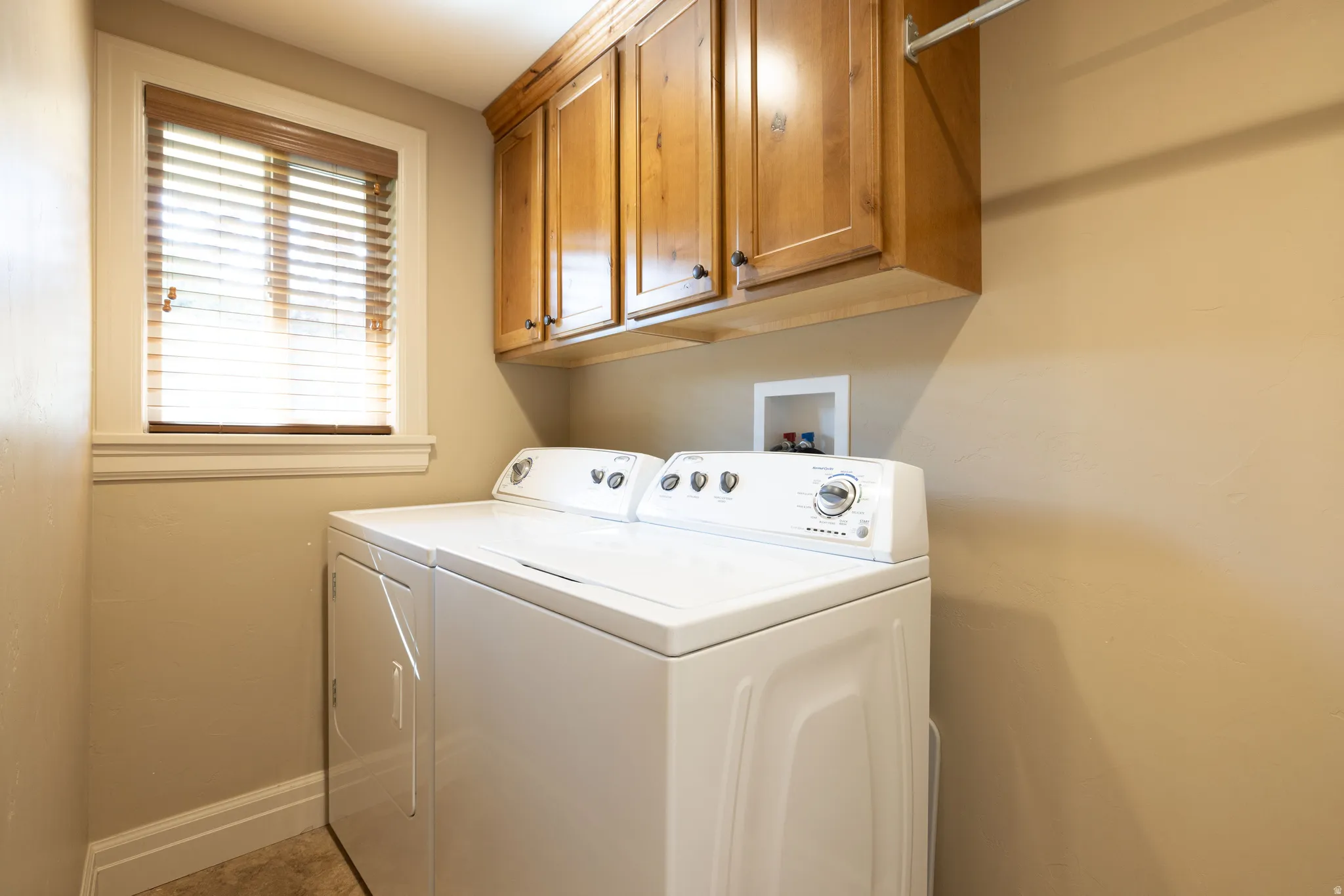 Laundry area with washer and clothes dryer and cabinet space