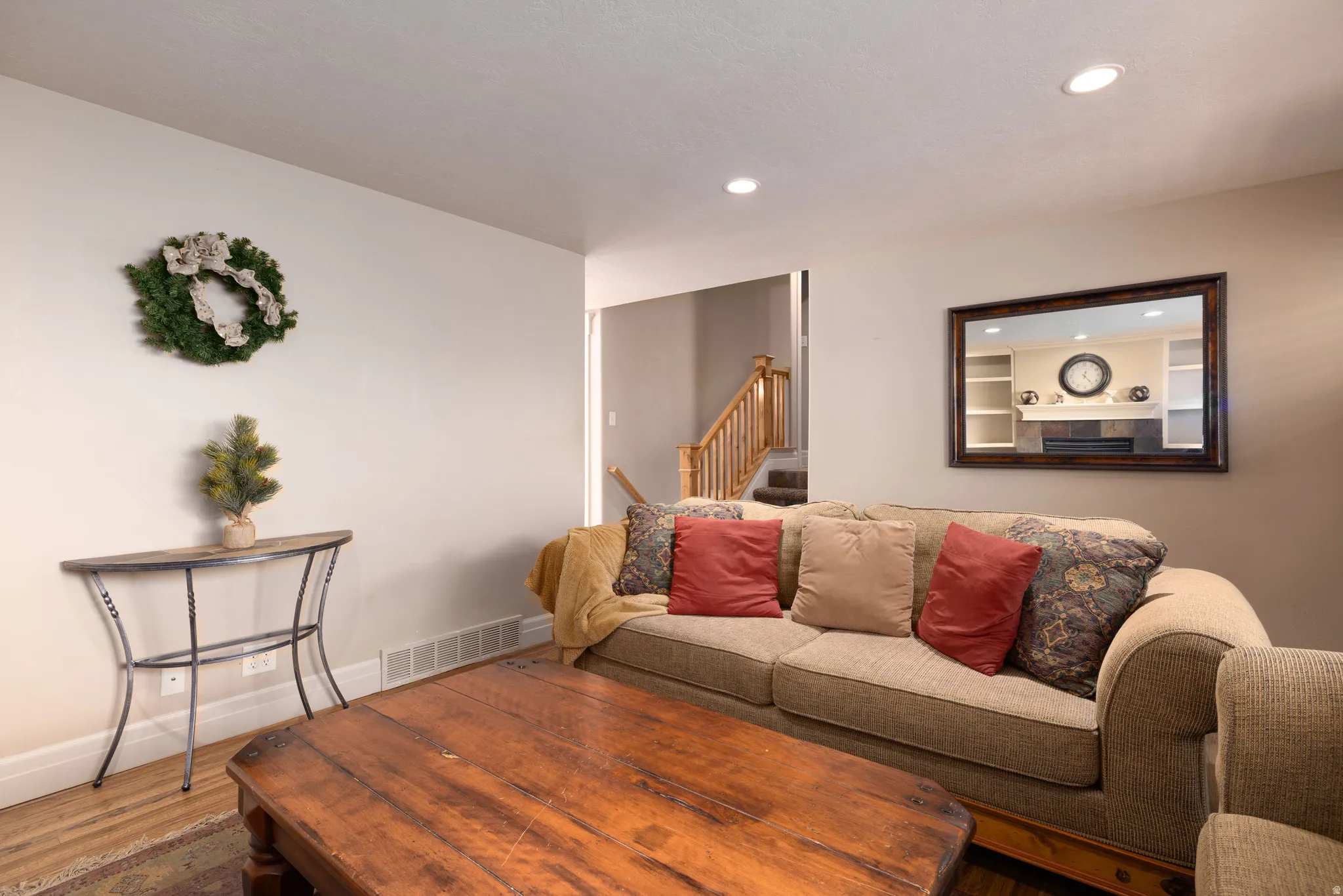 Living area with hardwood floors and recessed lighting
