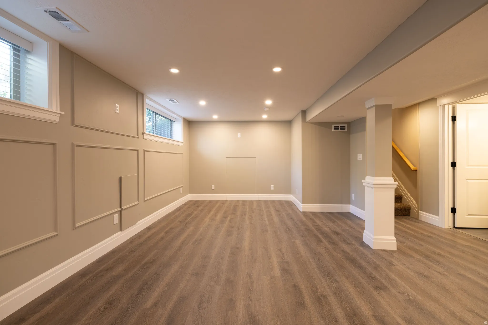 Below grade area with dark wood-type flooring and recessed lighting
