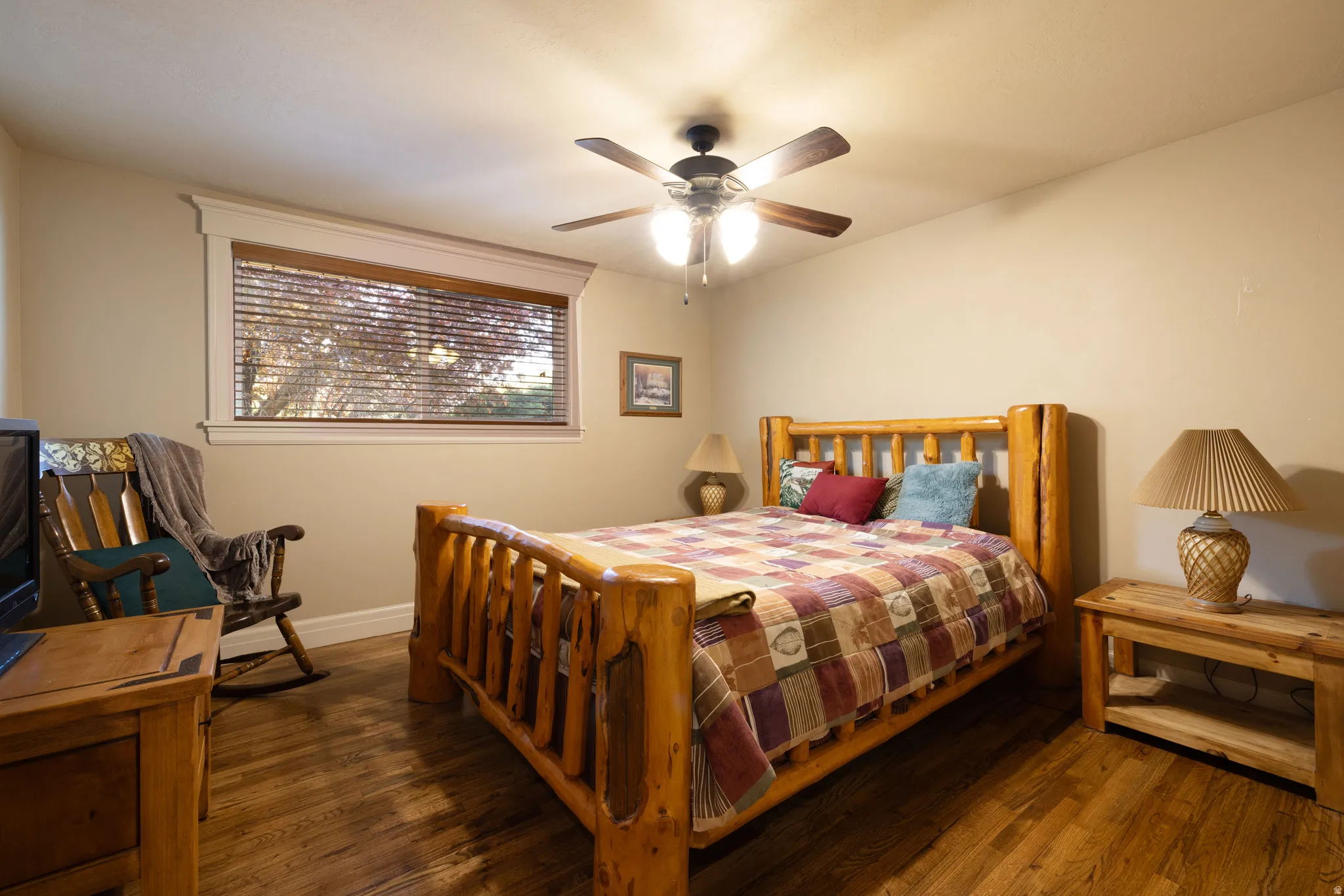 Bedroom featuring dark wood finished floors and a ceiling fan
