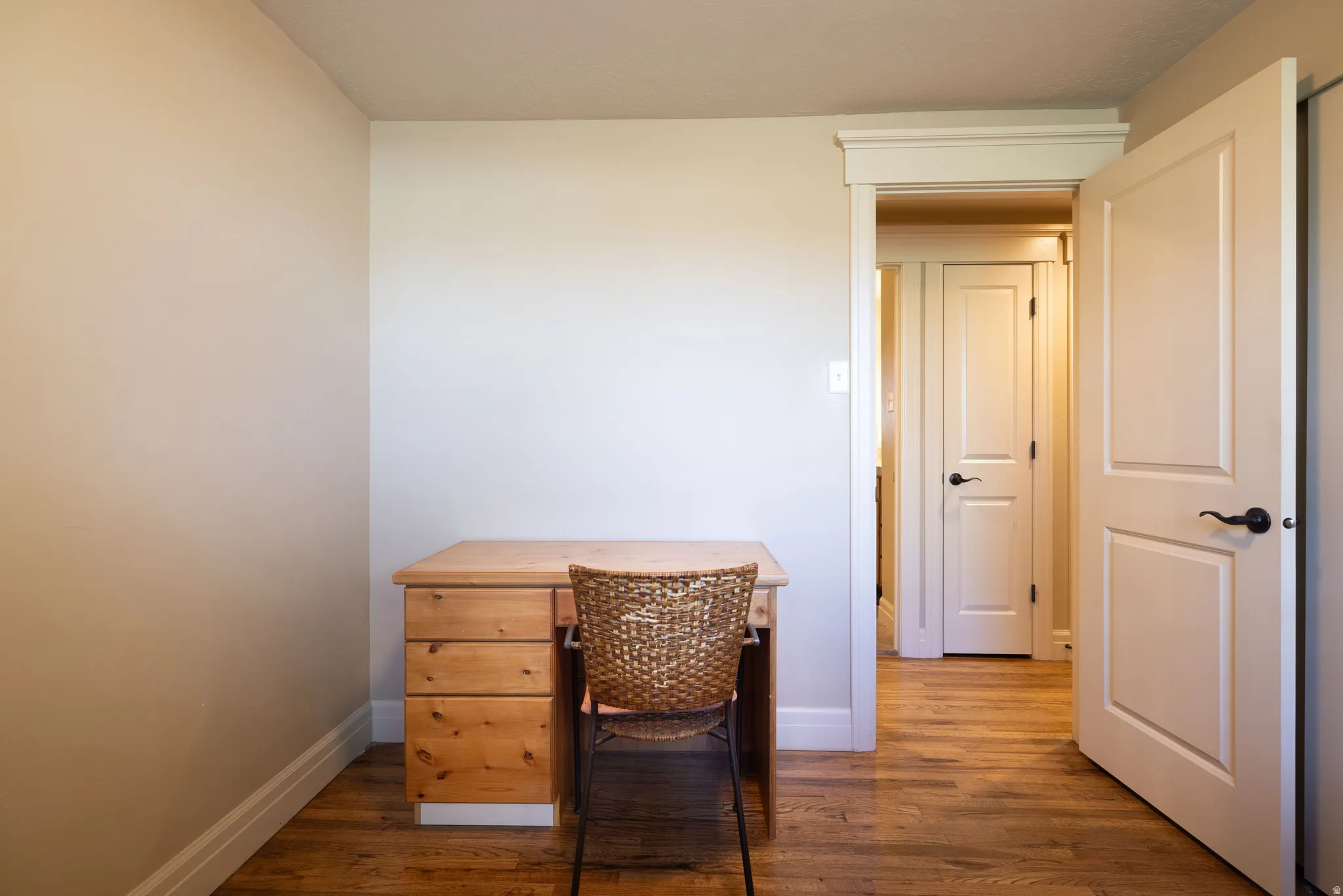 Corridor with an office area and dark wood finished floors