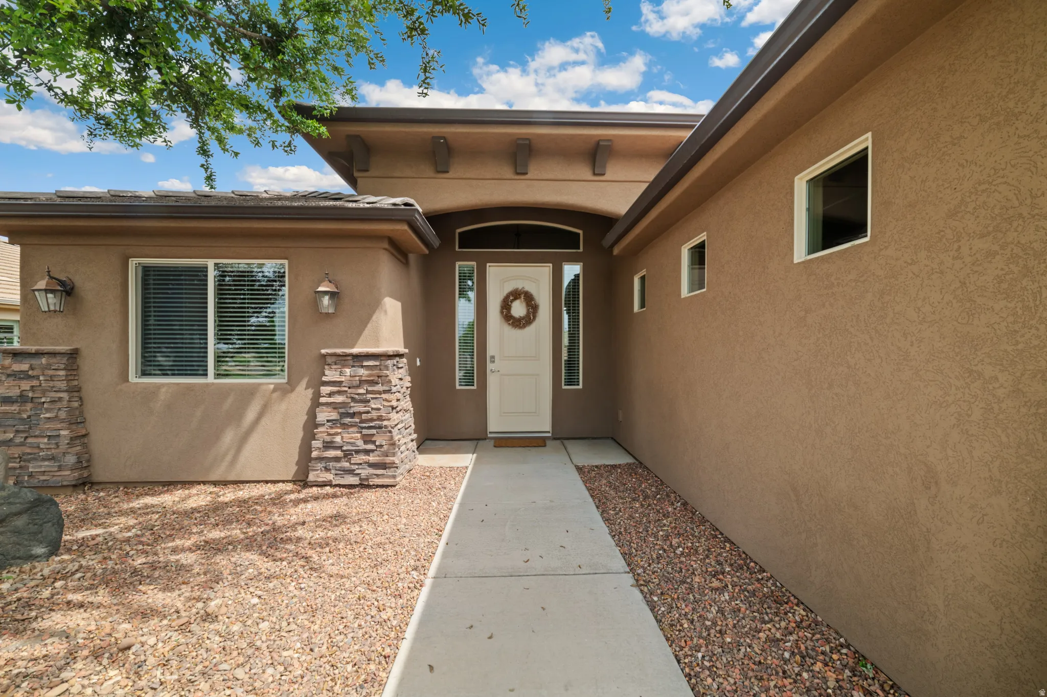 Property entrance featuring stucco siding