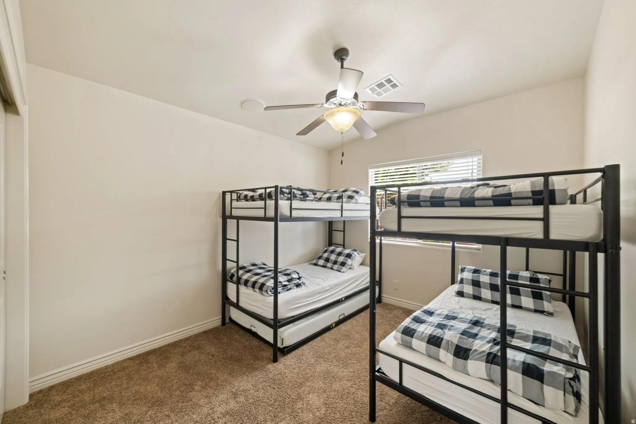 Bedroom with carpet floors and a ceiling fan
