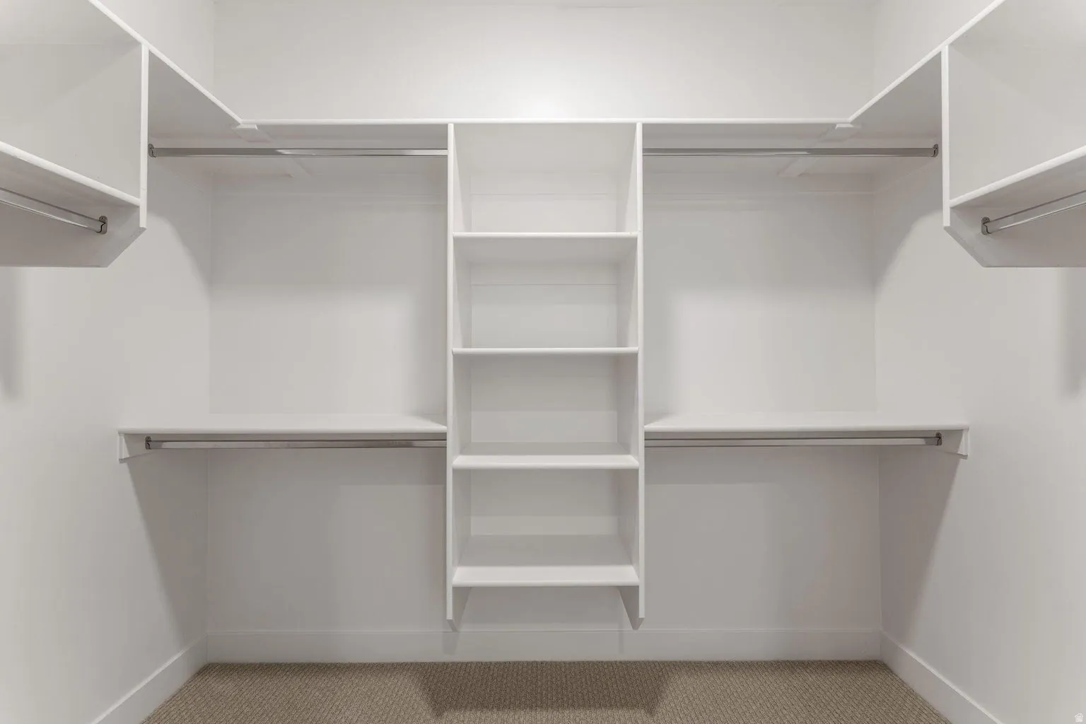 Walk in closet featuring light carpet
