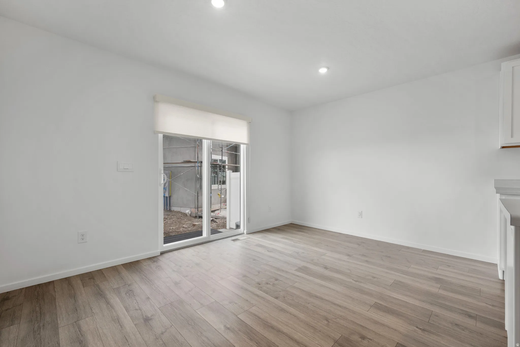 Unfurnished dining area with light wood-style flooring and recessed lighting