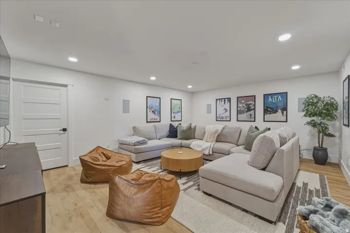 Living room with light wood-style floors and recessed lighting