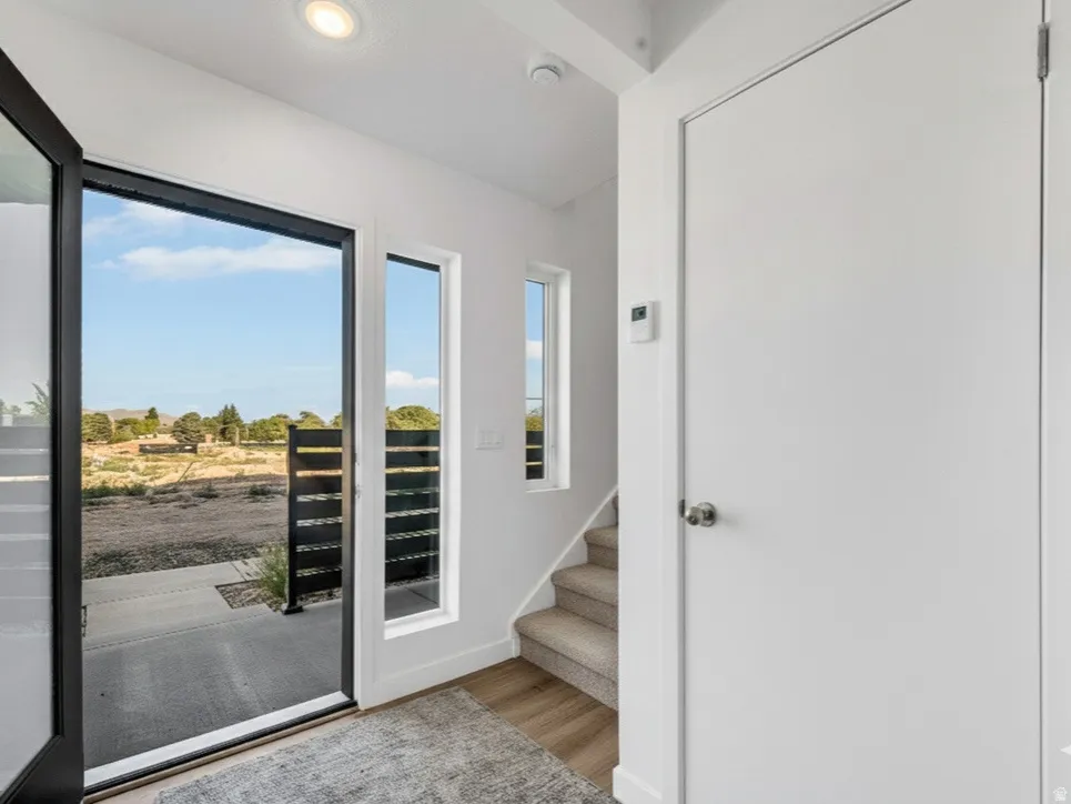 Entryway featuring wood finished floors and stairway