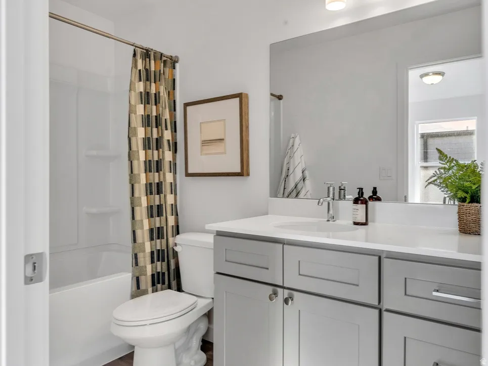 Full bath with vanity and shower / tub combo with curtain