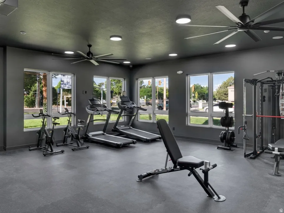 Gym featuring a ceiling fan, a textured ceiling, and recessed lighting