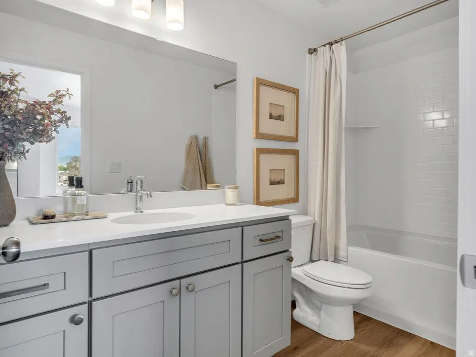 Bathroom featuring vanity, light wood-type flooring, and shower / tub combo