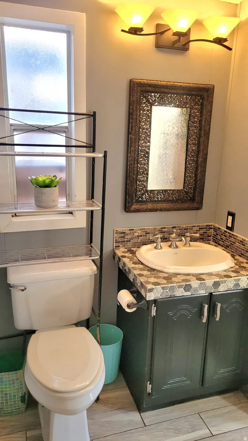 Full primary ensuite with vanity and wood finish floors