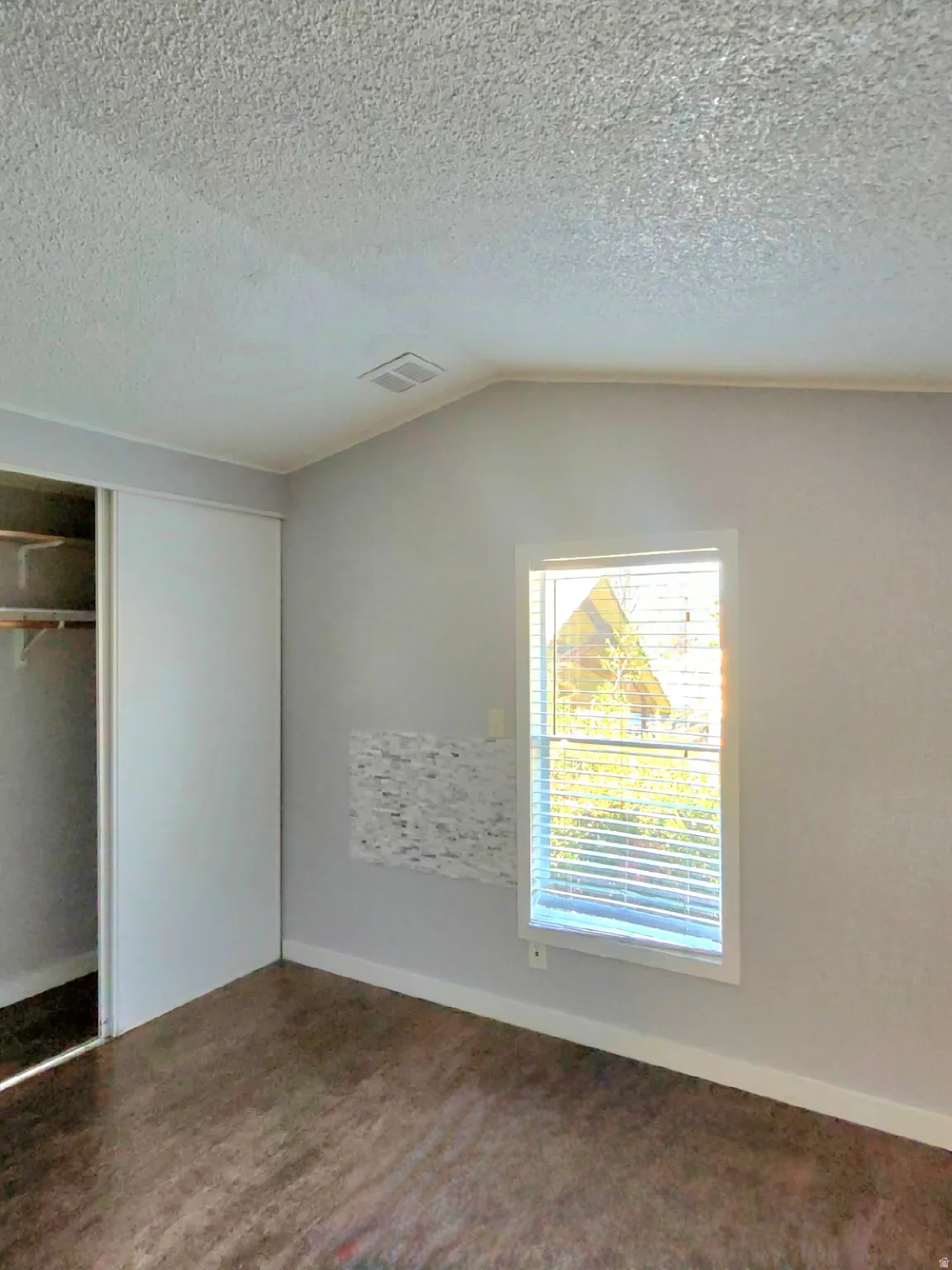 Unfurnished bedroom with a closet and baseboards