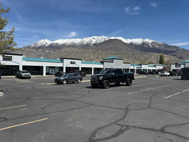 Uncovered parking lot featuring a mountain view