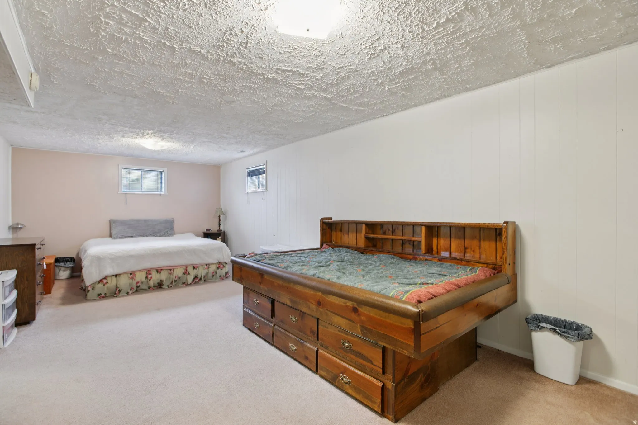 Carpeted bedroom with a textured ceiling