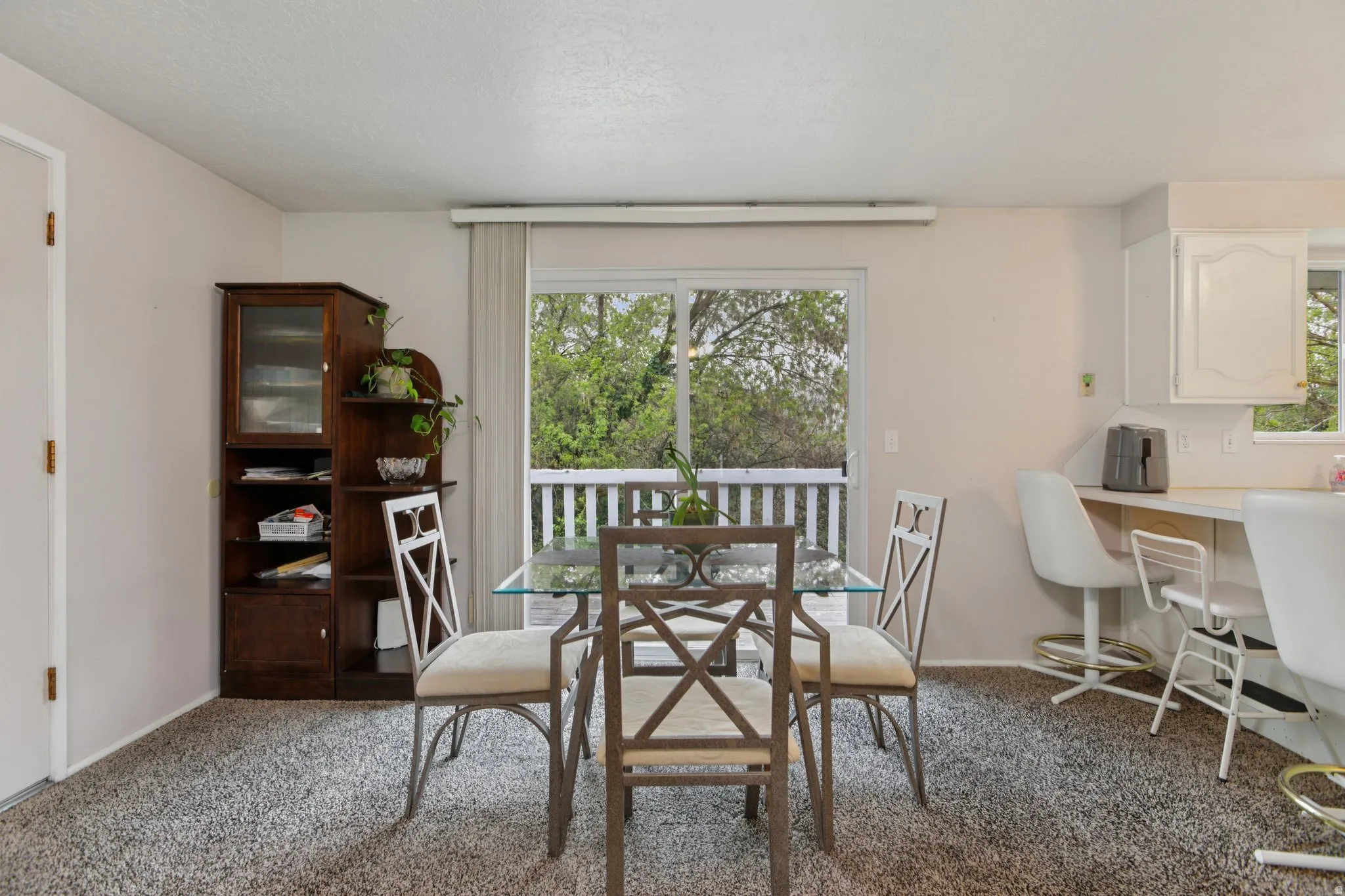 Dining space featuring light carpet and baseboards