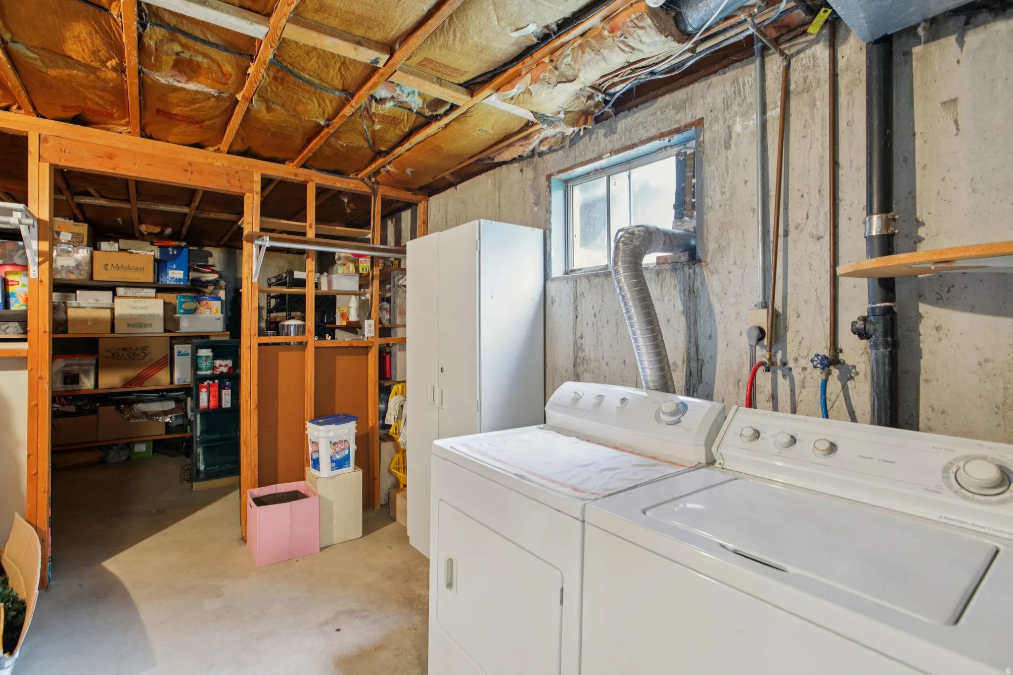 Laundry area with concrete flooring and washer and clothes dryer