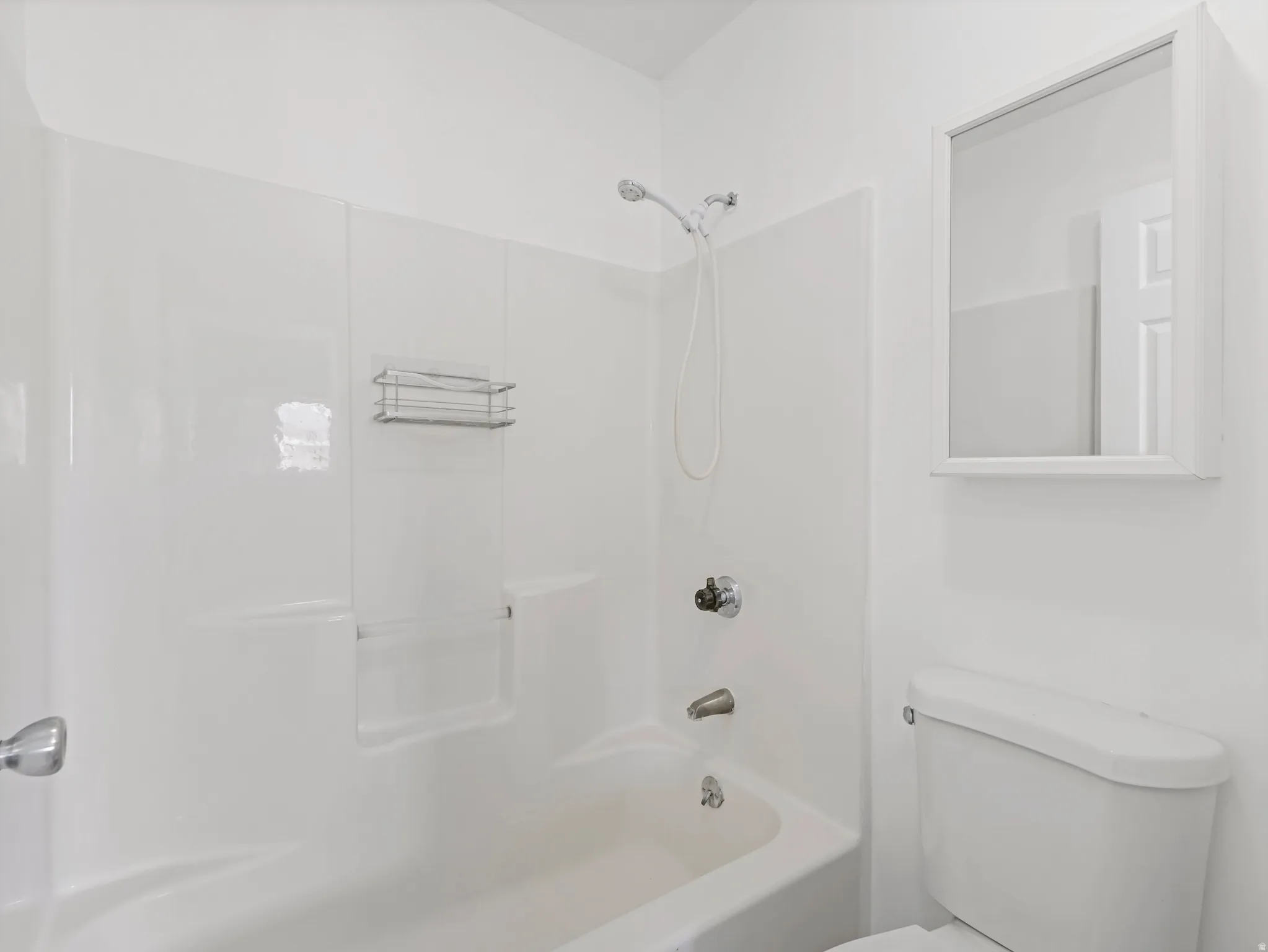 Bathroom featuring toilet and bathing tub / shower combination