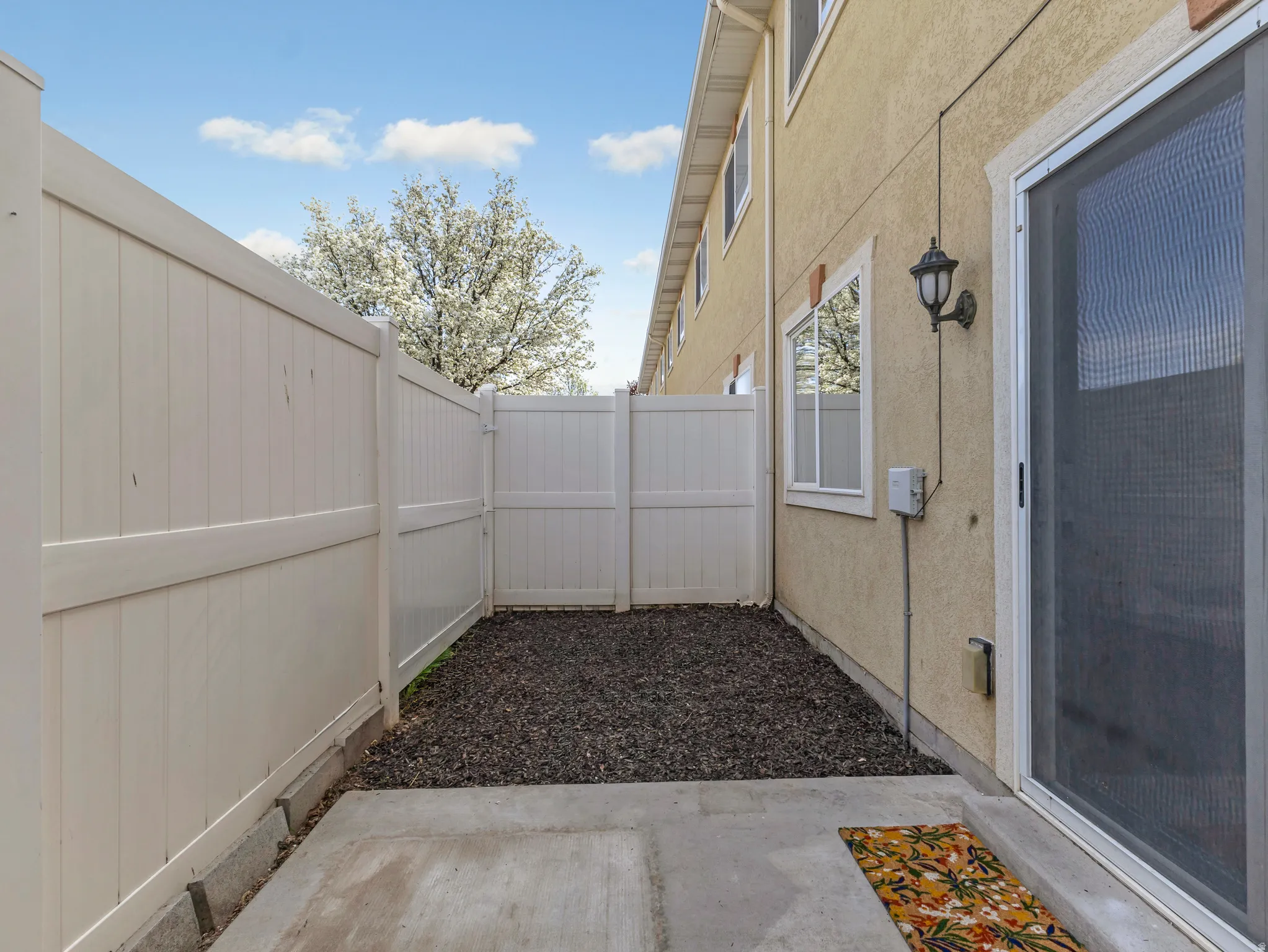 Fenced backyard with a patio area