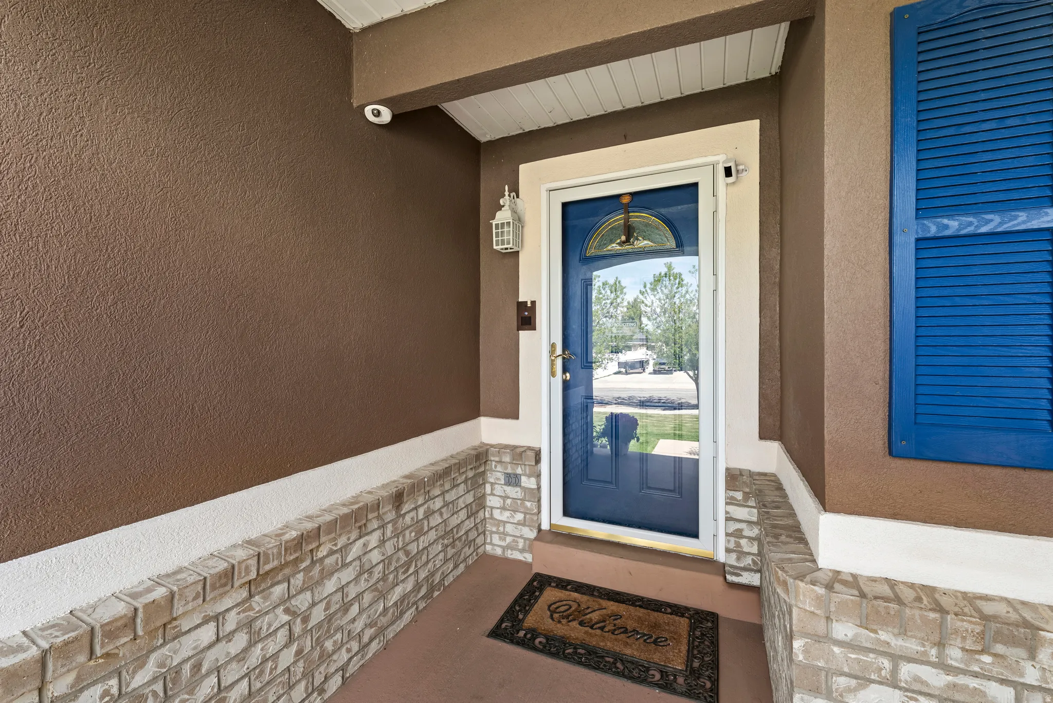 Entrance to property featuring stucco siding