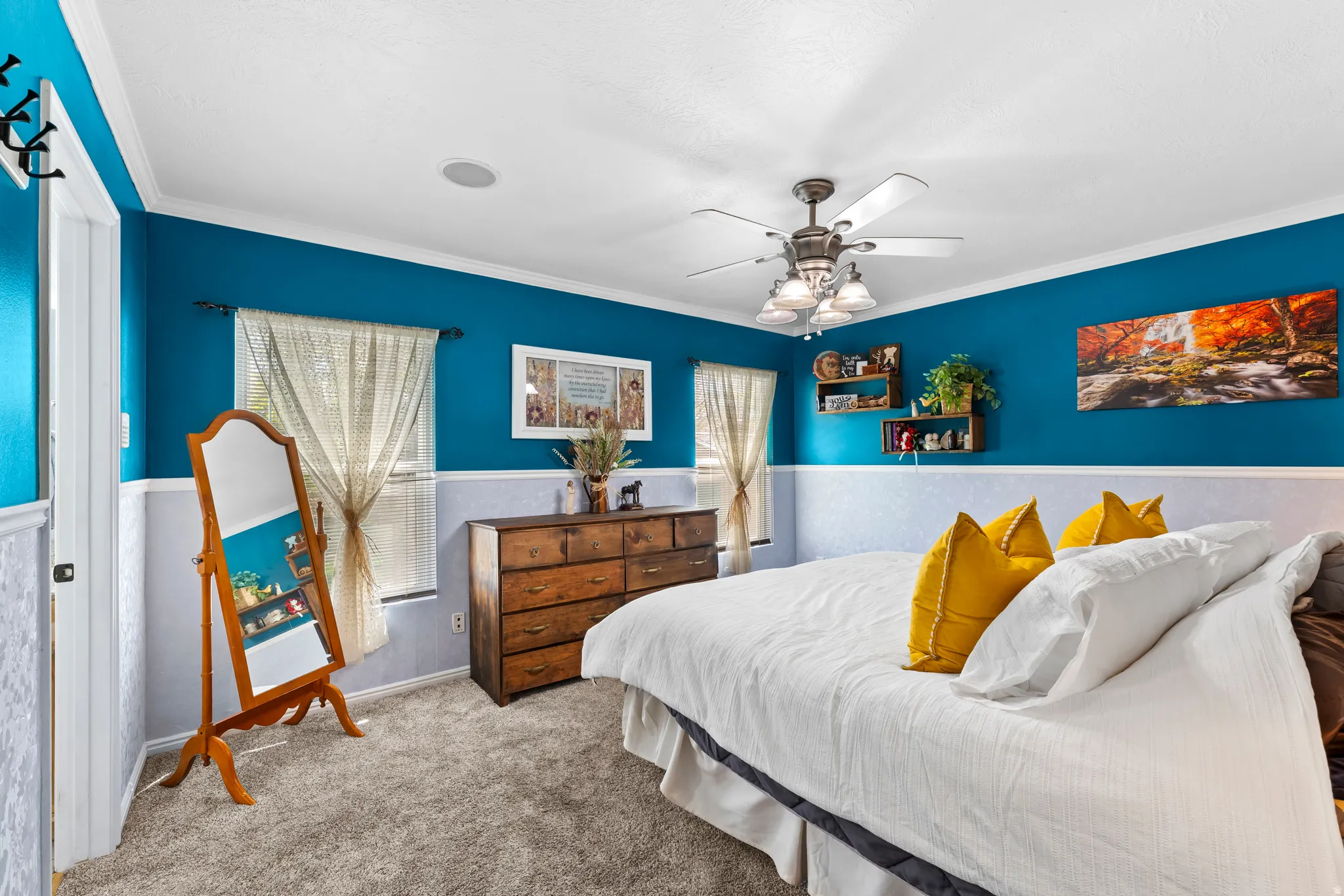 Primary bedroom with ceiling fan and en suite bath and walk-in closet