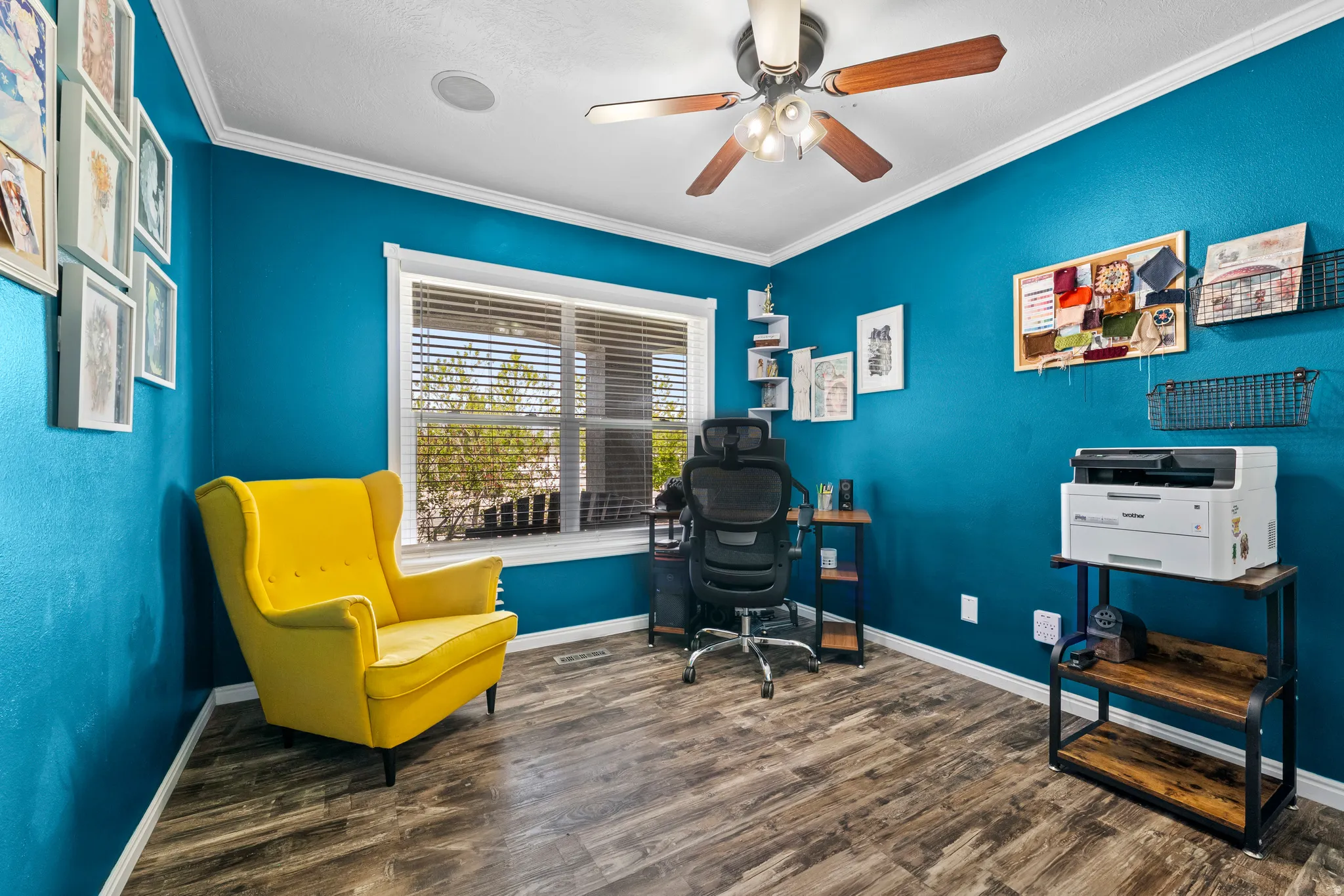Bedroom 3. Office space featuring dark wood-style floors, ornamental molding, and a ceiling fan