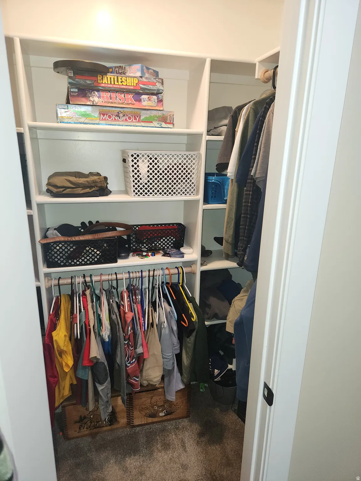 Walk in closet featuring dark carpet