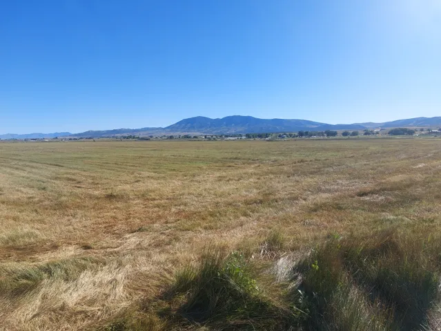 View of mountain backdrop featuring rural landscape