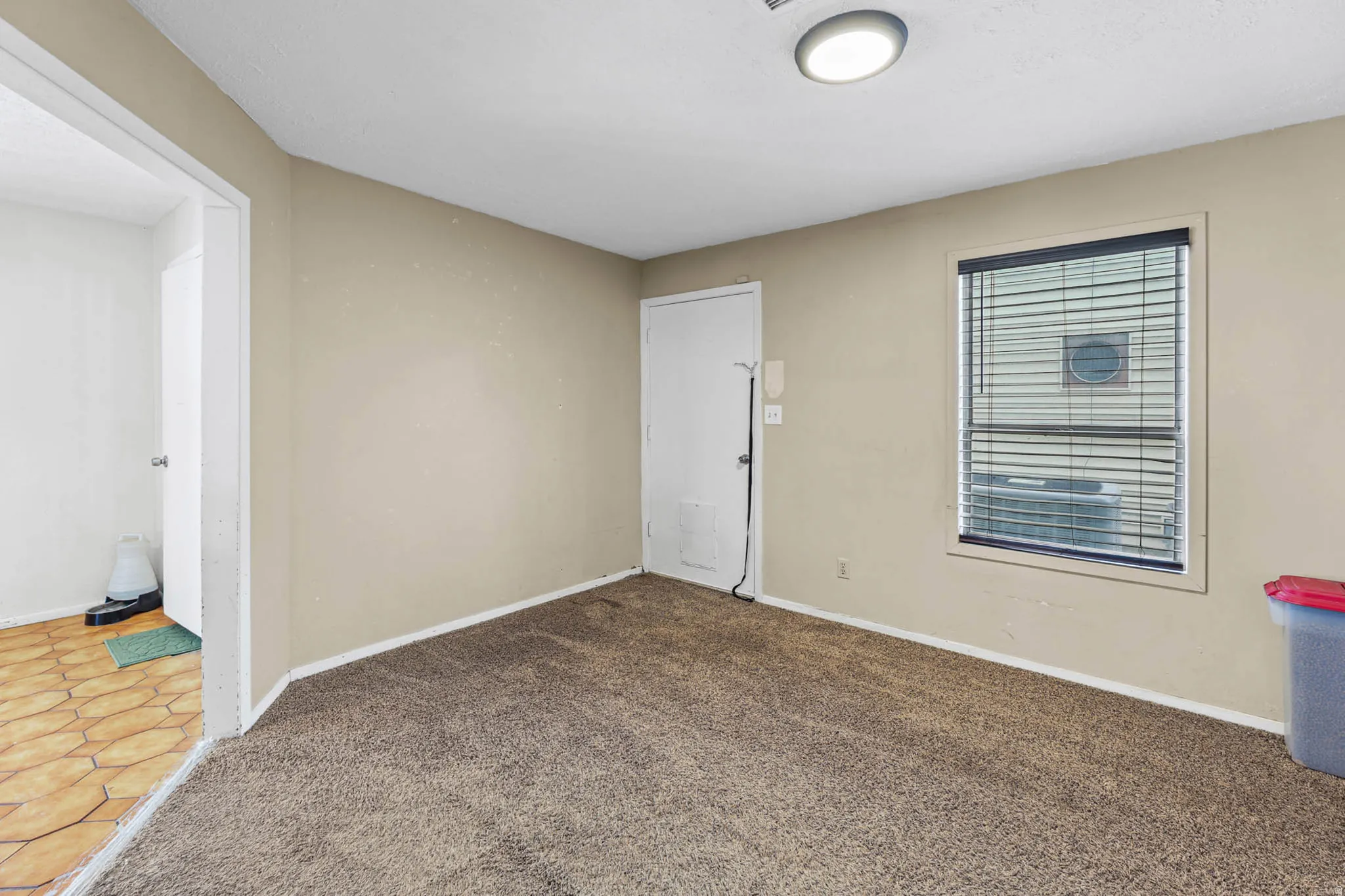 Carpeted empty room featuring baseboards