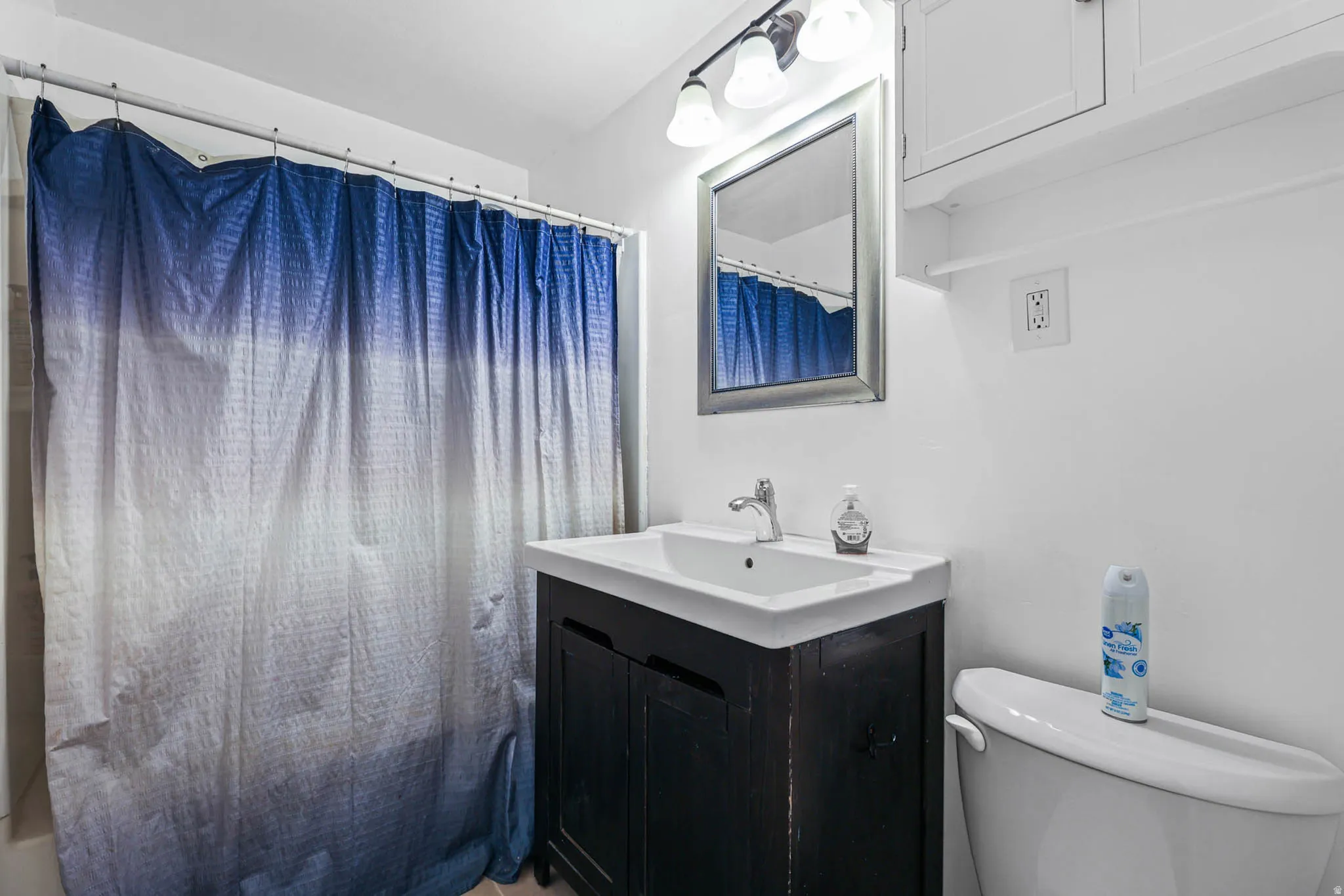 Full bathroom with vanity and shower / bath combo with shower curtain