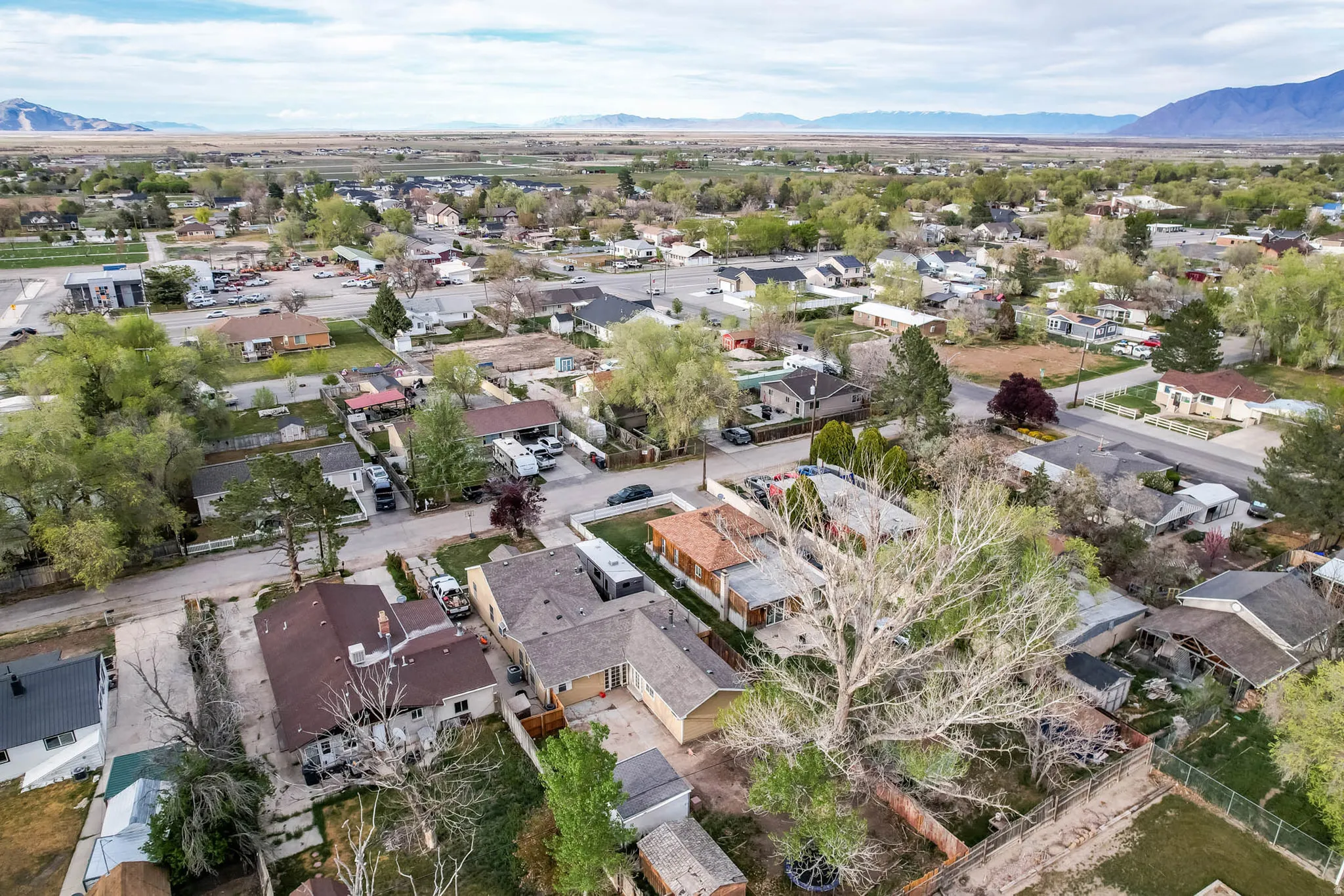 Aerial overview of property's location featuring nearby suburban area and a mountain backdrop