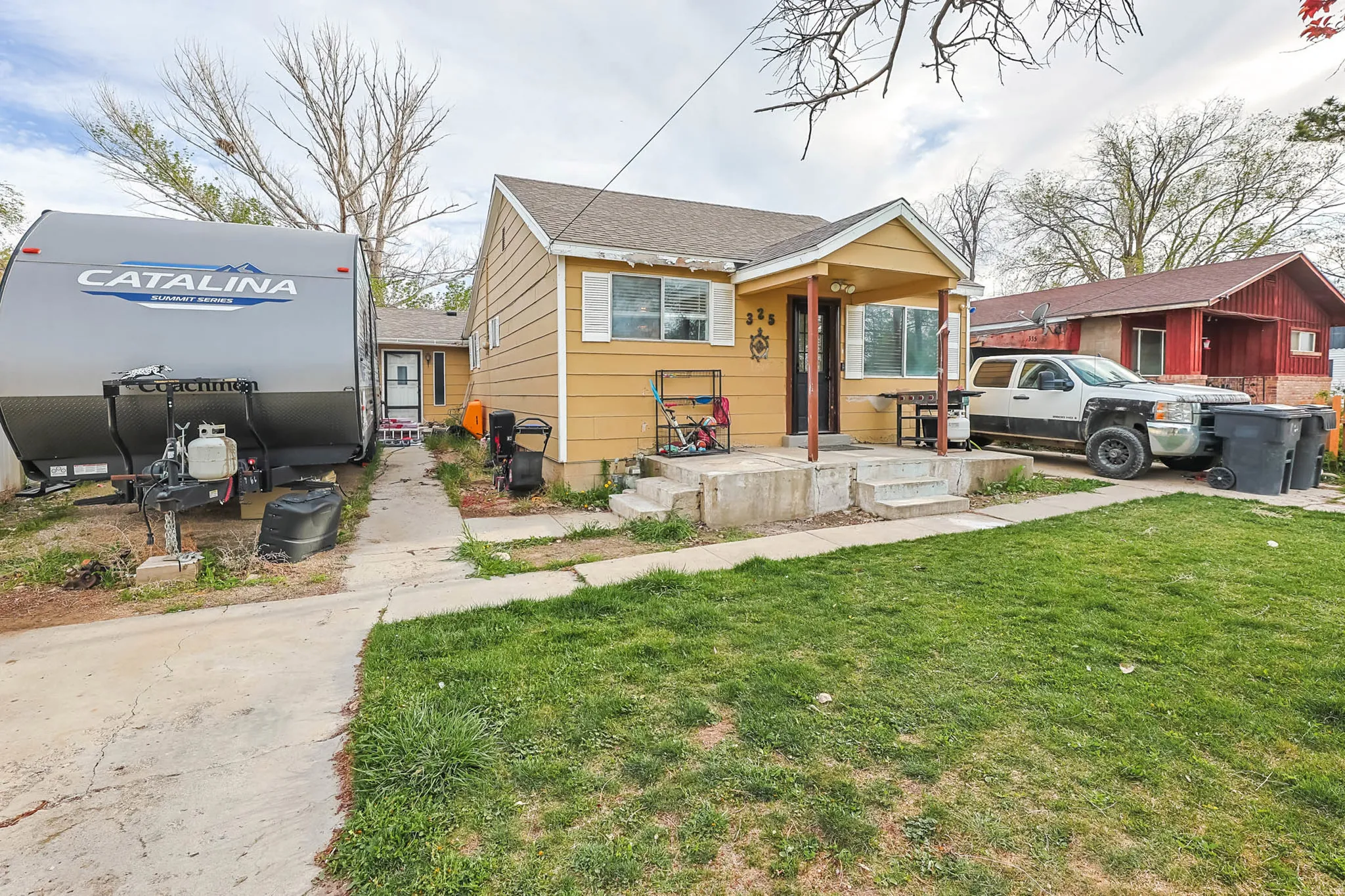 Bungalow with a front yard and a shingled roof