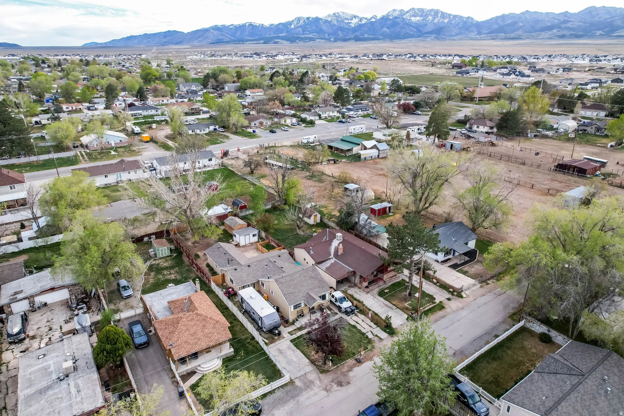Aerial perspective of suburban area featuring a mountain backdrop