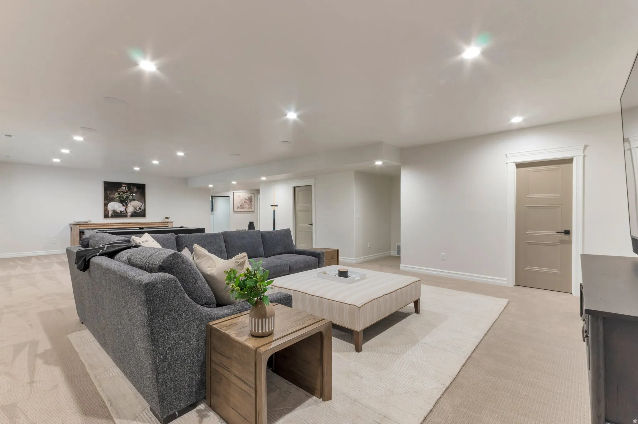 Living area featuring light carpet and recessed lighting
