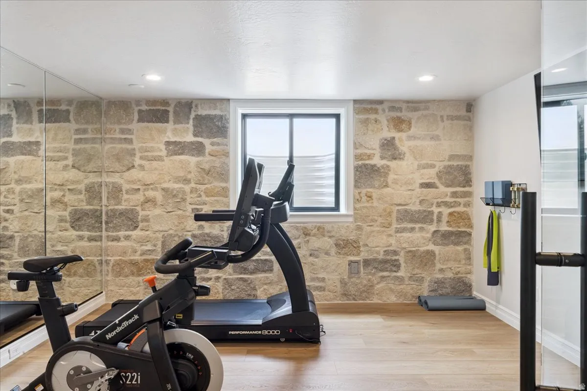 Exercise area featuring light wood-style flooring