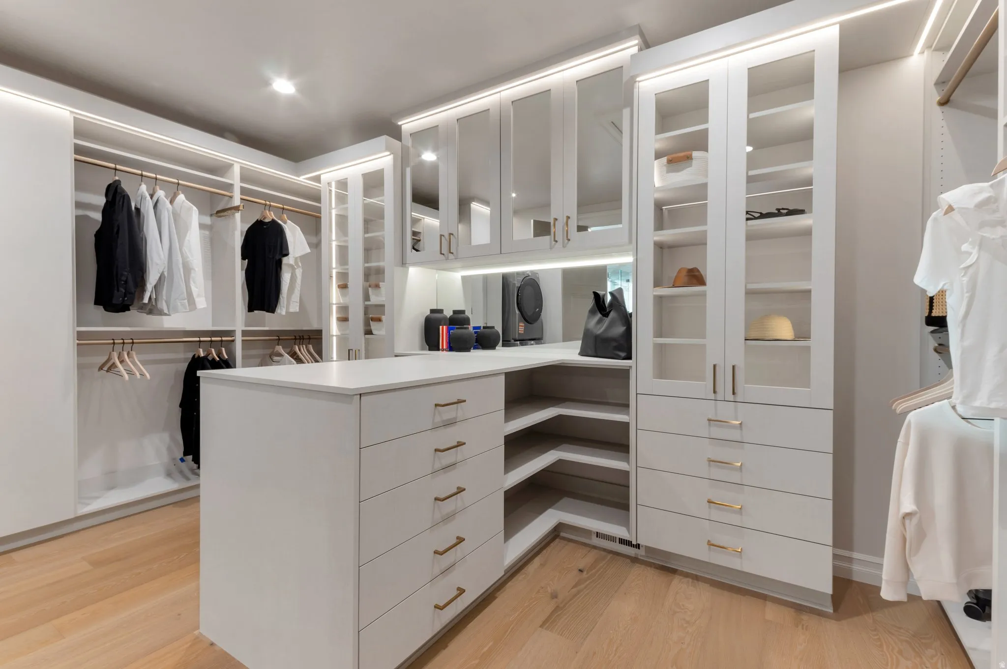 Walk in closet with light wood-style flooring