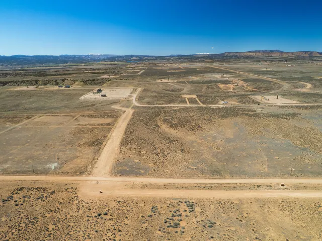 Aerial view of sparsely populated area featuring a desert landscape and a mountain backdrop