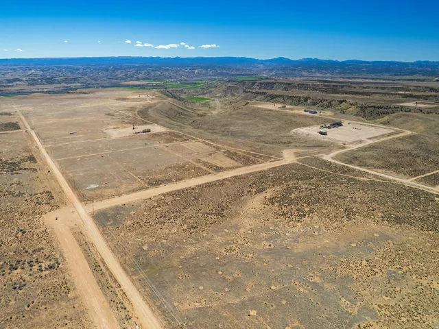 View of rural area with a desert landscape and a mountainous background
