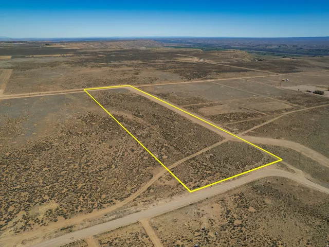 Aerial view of sparsely populated area featuring a desert landscape and property boundaries highlighted