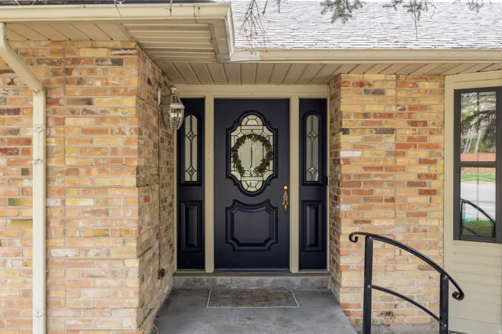 Well cared for, secluded front door with sidelight details.
