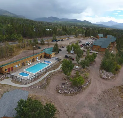 Drone / aerial view of a pool area and mountains