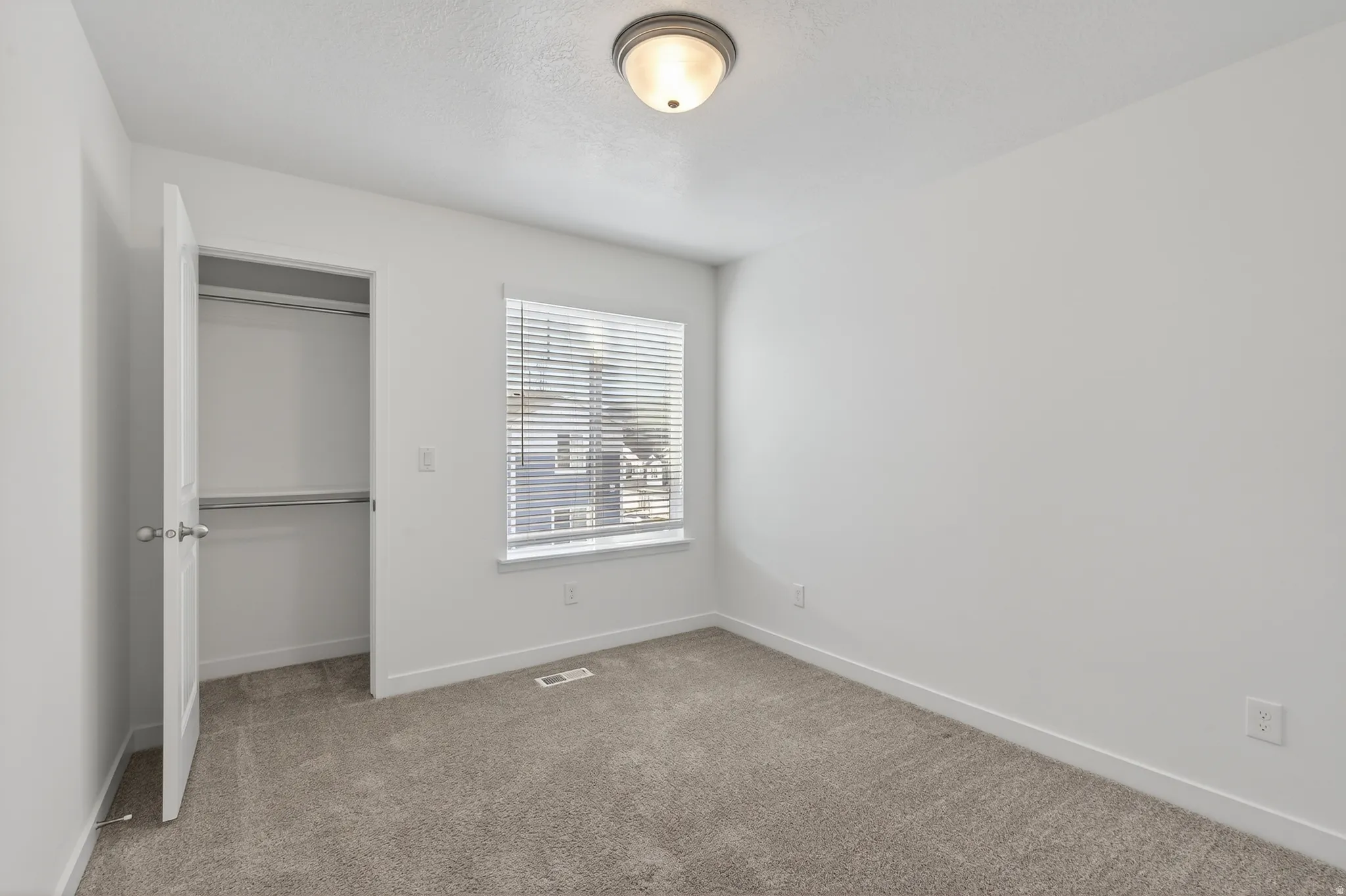 Unfurnished bedroom featuring carpet floors and a closet
