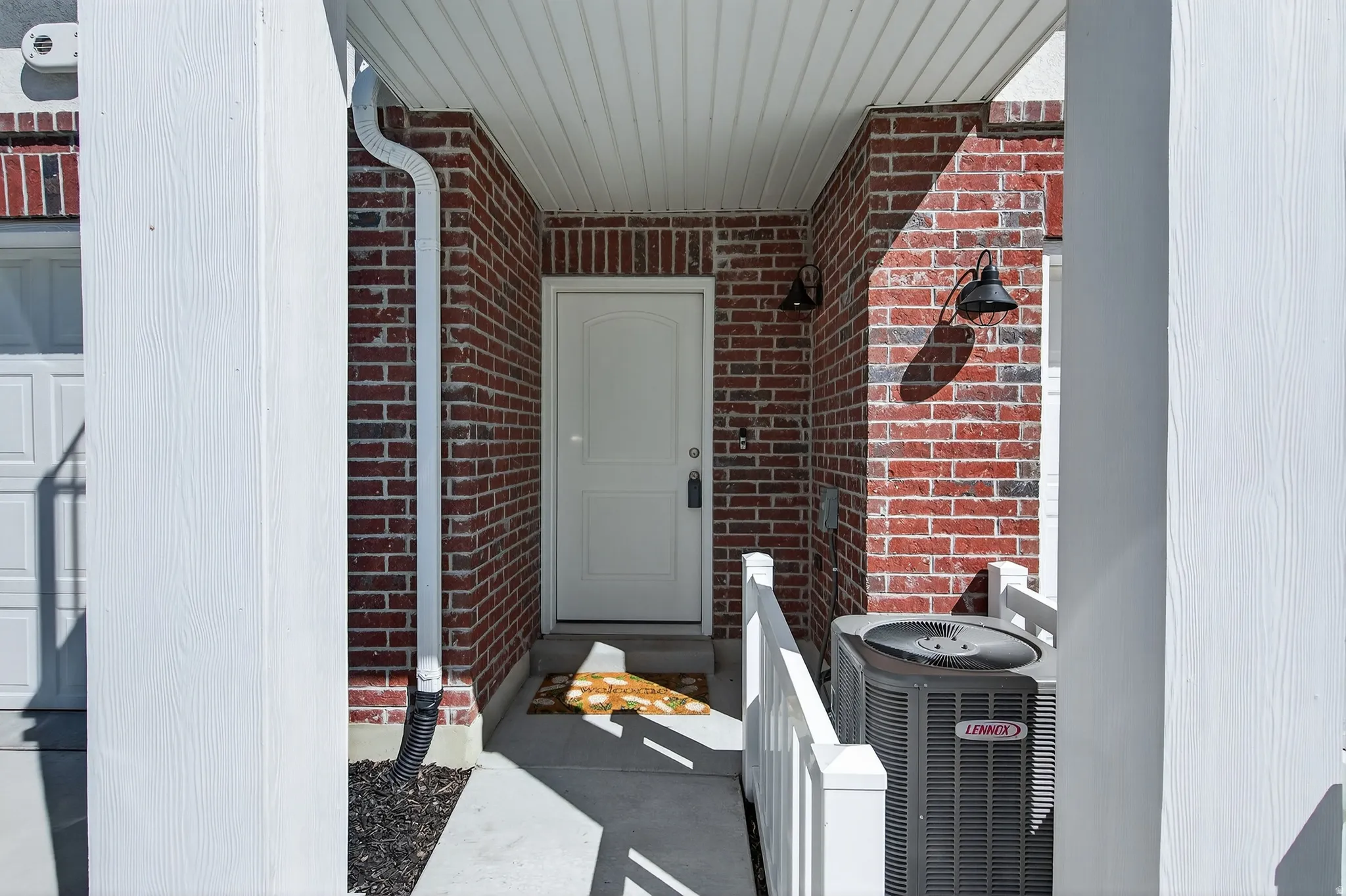 Property entrance with brick siding and covered porch