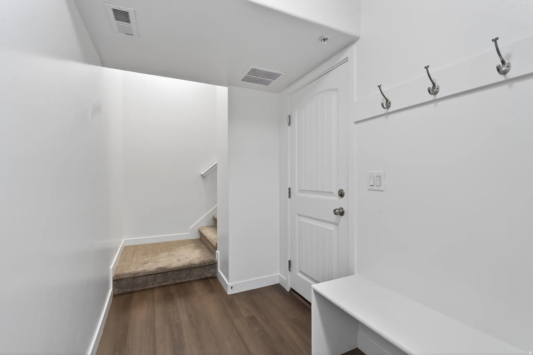Mudroom with baseboards and dark wood-style flooring