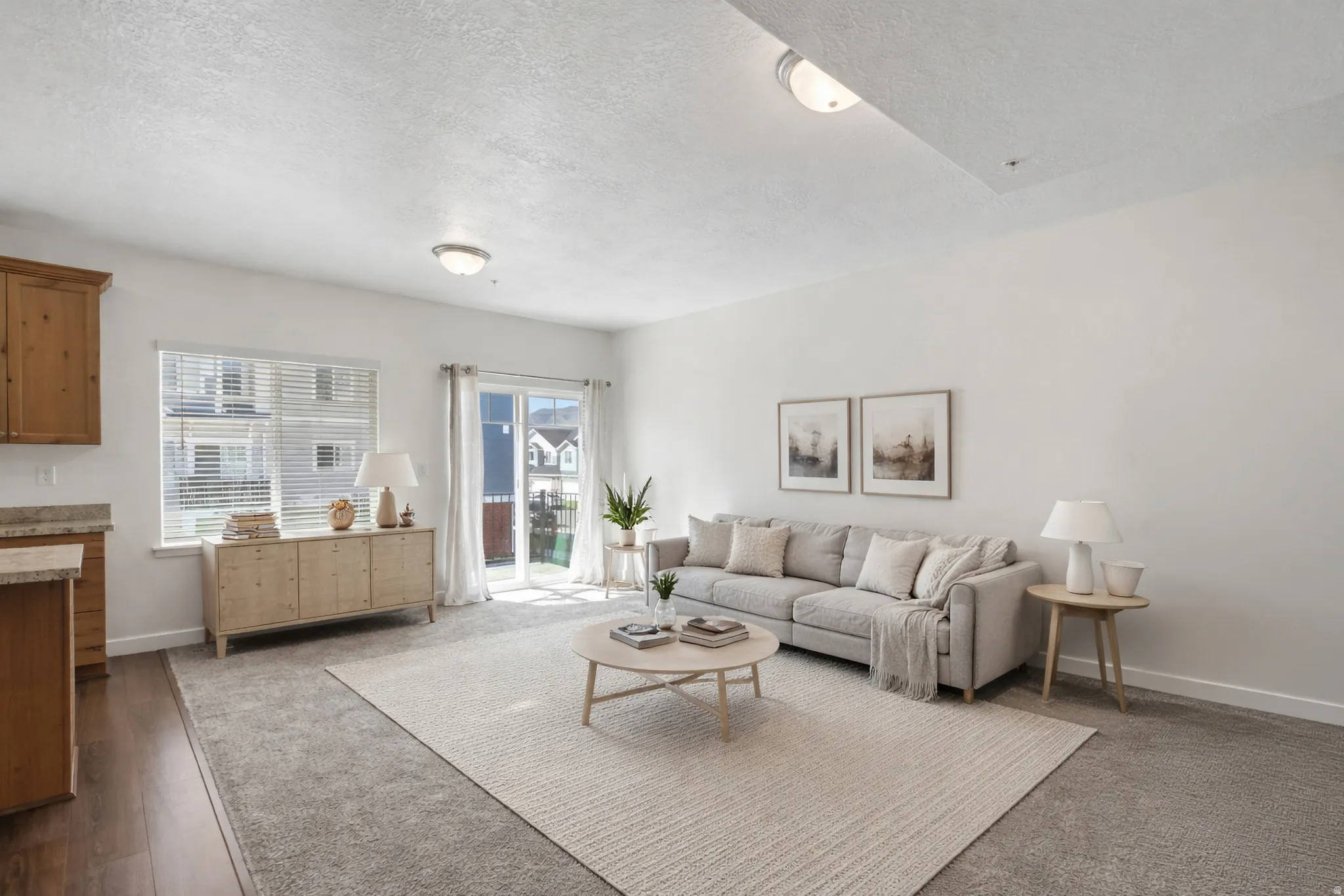 Living room with a textured ceiling and dark carpet